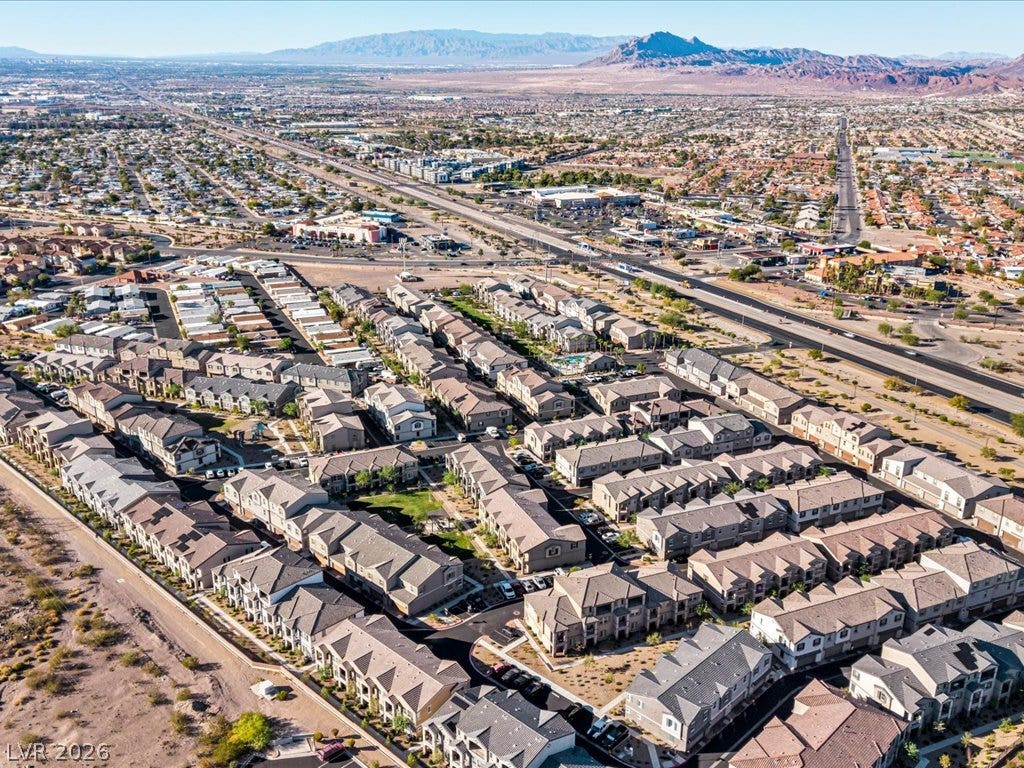 671 Foam Flower Lane, Henderson, NV 89015 An expansive valley layout unfolds toward distant mountains in this sweeping aerial perspective.
