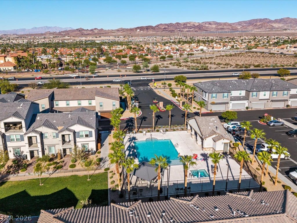 671 Foam Flower Lane, Henderson, NV 89015 Dramatic mountain vistas frame the community swimming pool and surrounding residential structures.