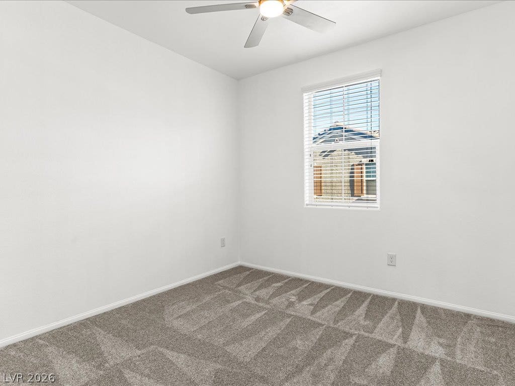 671 Foam Flower Lane, Henderson, NV 89015 Plush carpeting and a classic multi-pane window create a comfortable and inviting atmosphere.