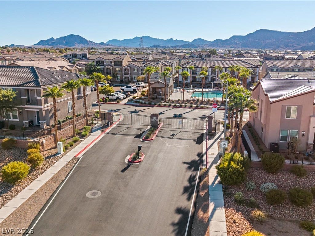 671 Foam Flower Lane, Henderson, NV 89015 A gated entry leads into a desert community framed by dramatic mountain backdrops.