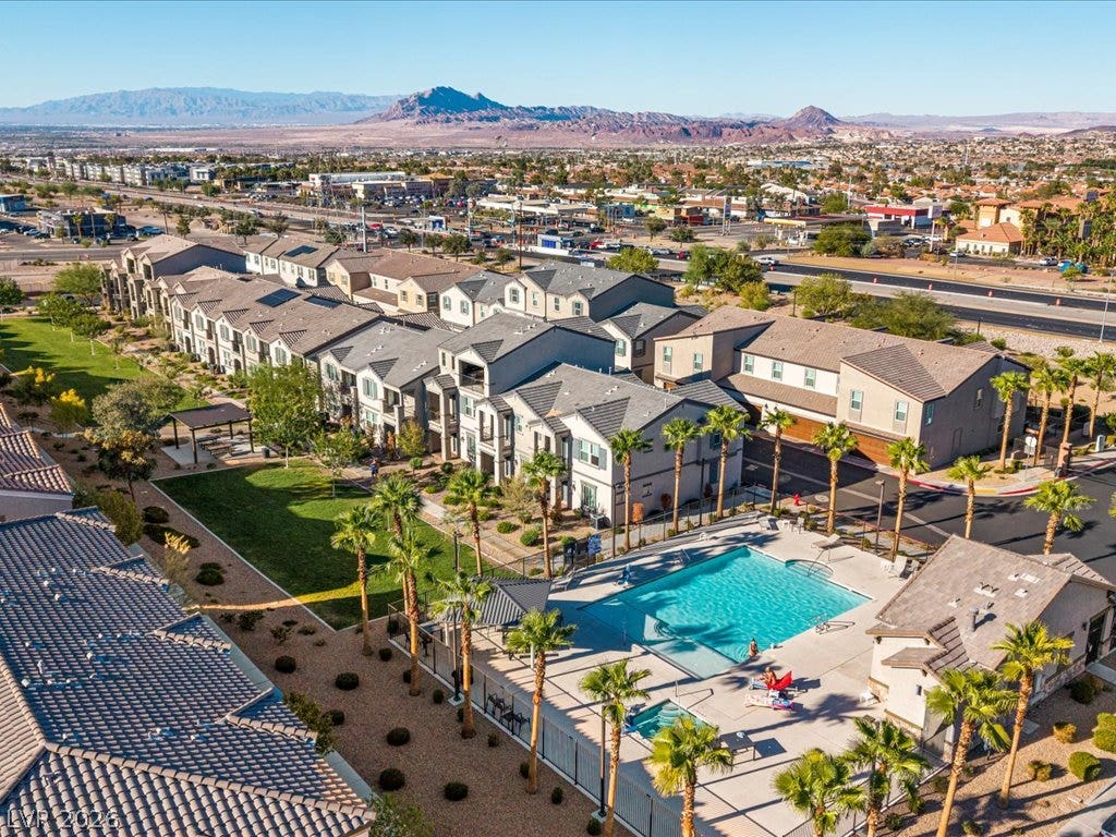 671 Foam Flower Lane, Henderson, NV 89015 Dramatic mountain vistas frame the community buildings, swimming pool, and landscaped green space.