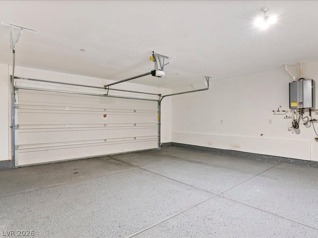671 Foam Flower Lane, Henderson, NV 89015 A spacious garage includes durable epoxy flooring and a modern tankless water heater.