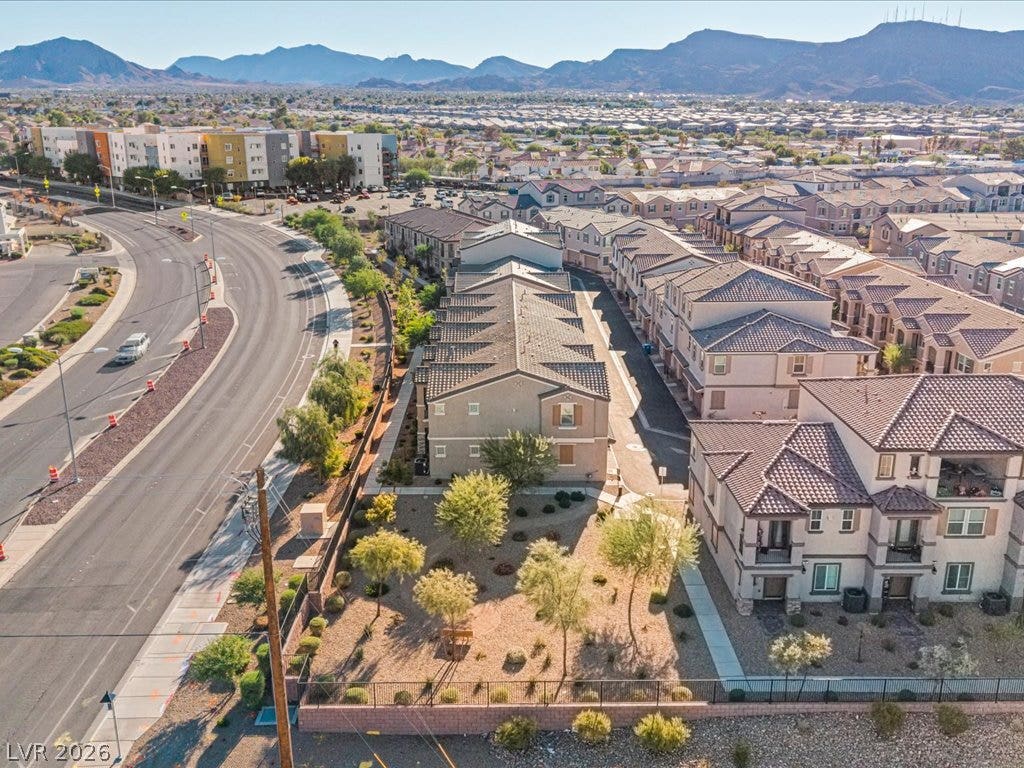 671 Foam Flower Lane, Henderson, NV 89015 Desert landscaping surrounds these multi-level townhomes set against a backdrop of majestic mountains.