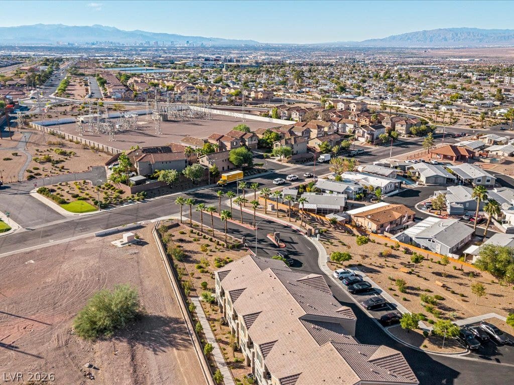 671 Foam Flower Lane, Henderson, NV 89015 Distancing mountains frame a sweeping aerial vista of the neighborhood and surrounding desert landscape.