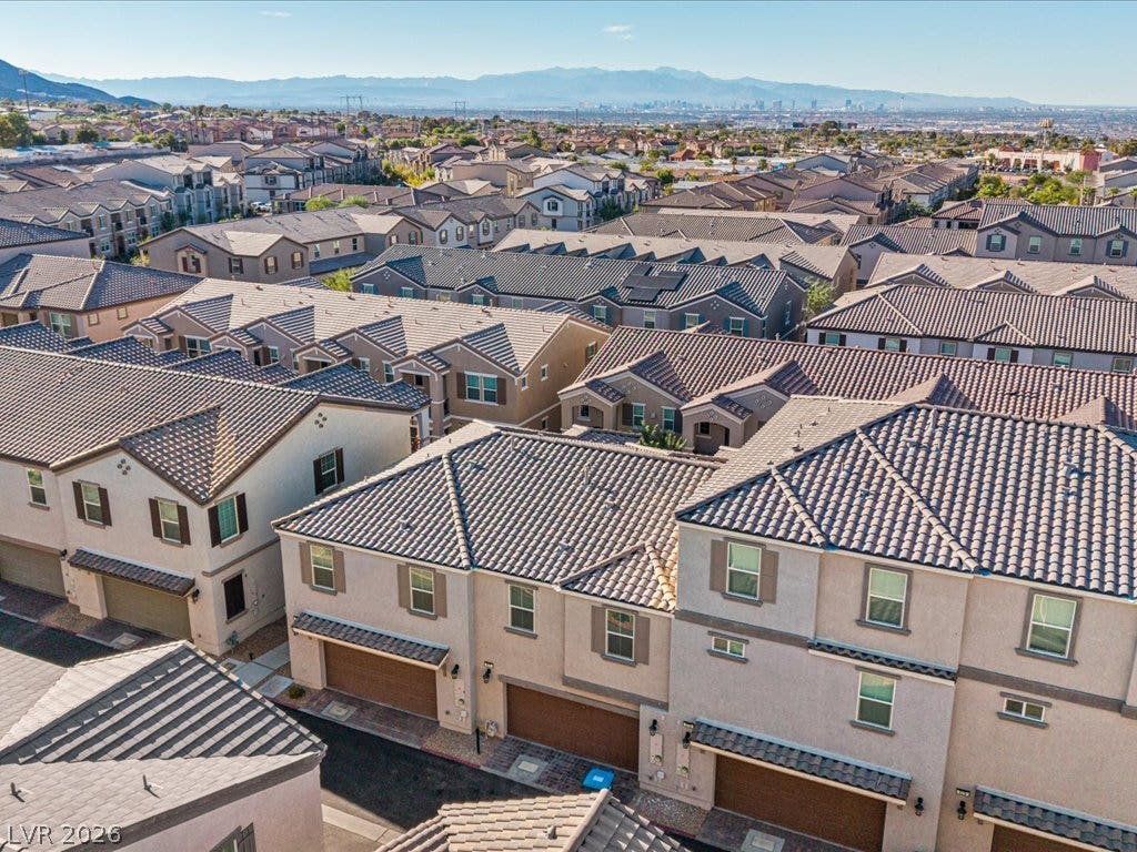 671 Foam Flower Lane, Henderson, NV 89015 A sweeping community view reveals matching tile rooflines set against distant mountain ranges.