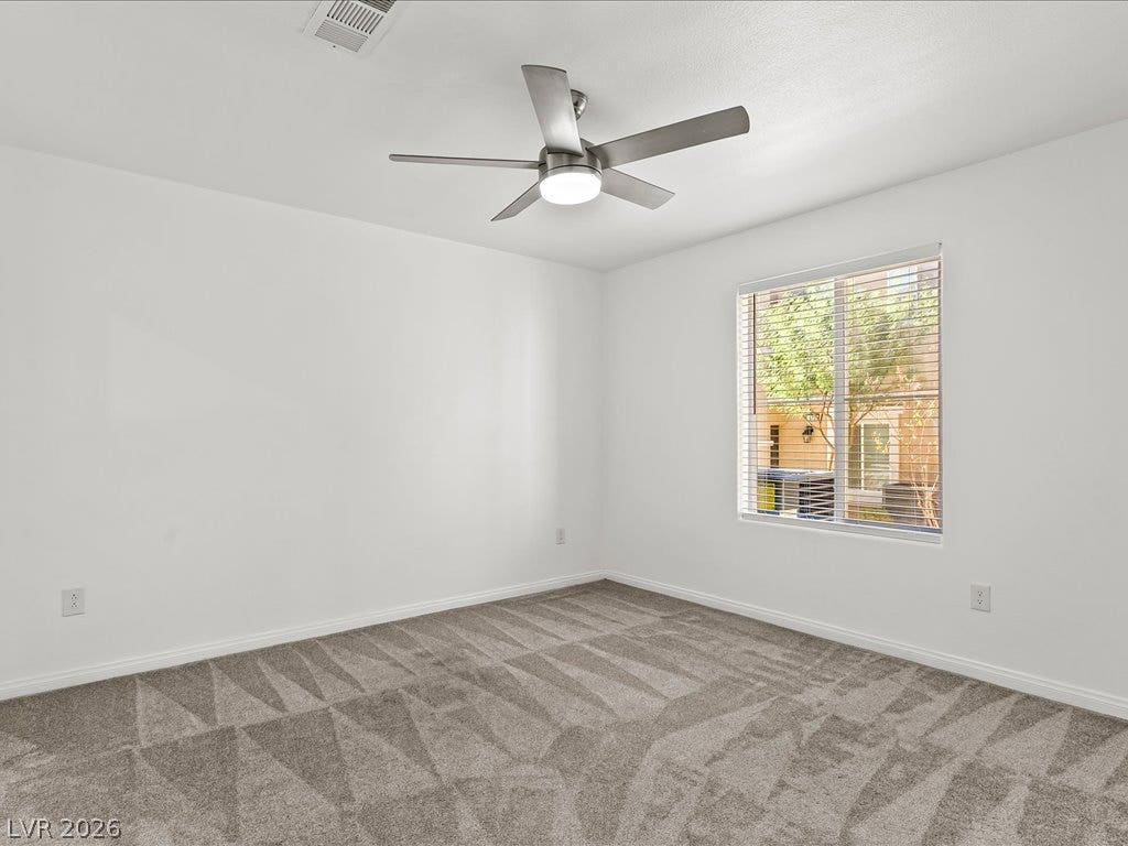 671 Foam Flower Lane, Henderson, NV 89015 Plush carpeting and a large window looking out to the yard define this bedroom.