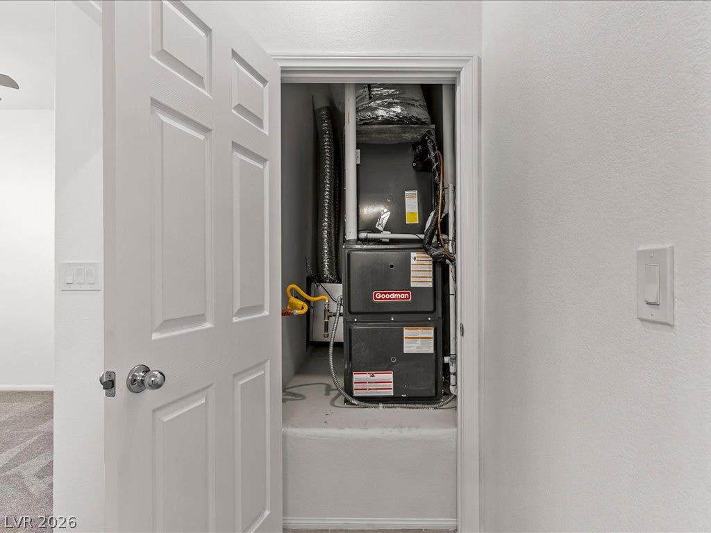 671 Foam Flower Lane, Henderson, NV 89015 A dedicated closet space houses the home heating system behind a classic paneled door.