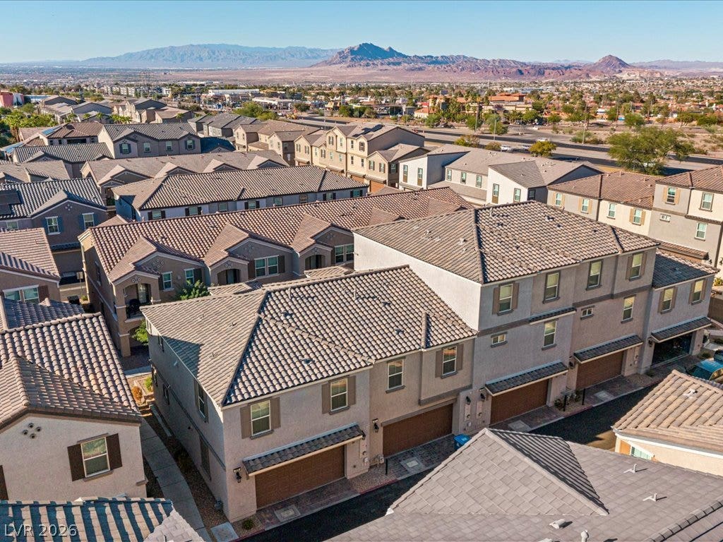 671 Foam Flower Lane, Henderson, NV 89015 Dramatic mountain vistas frame this neighborhood of modern multi-level townhomes with tile roofing.