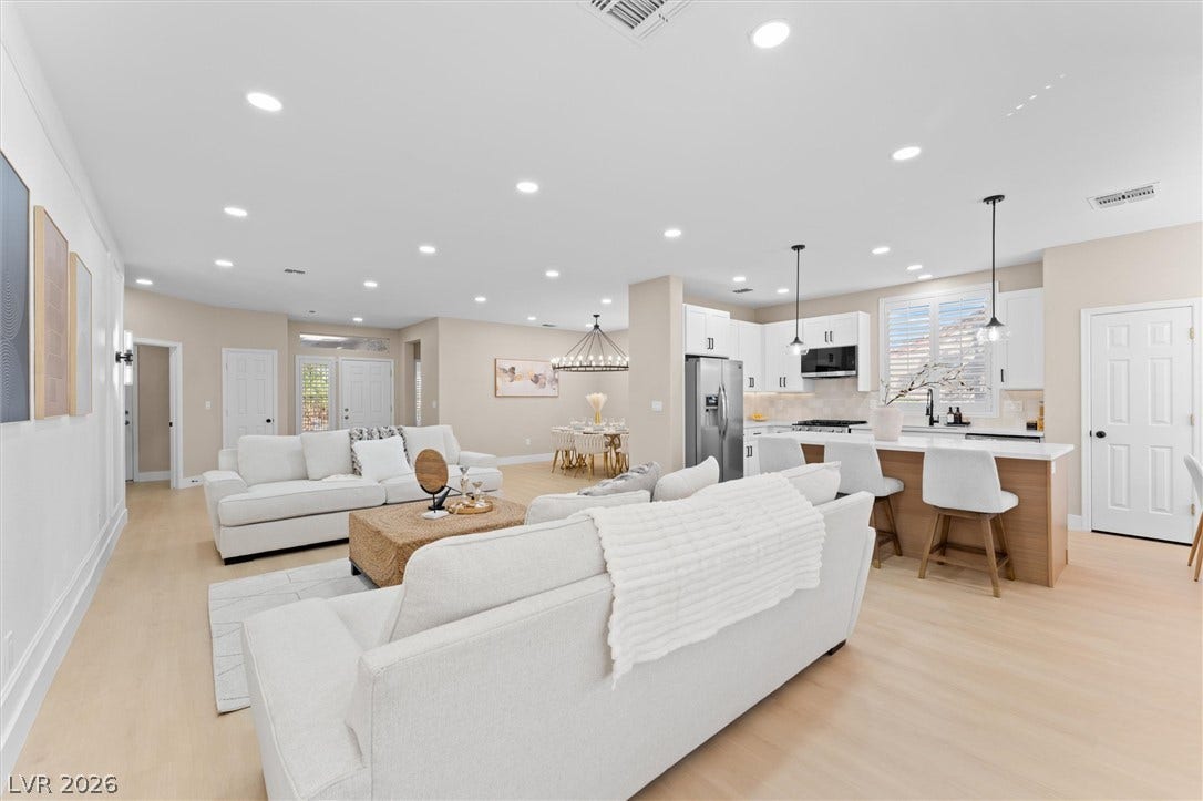 2163 Chapman Ranch Drive, Henderson, NV 89012 Recessed lighting illuminates this seamless open floorplan with light wood floors.