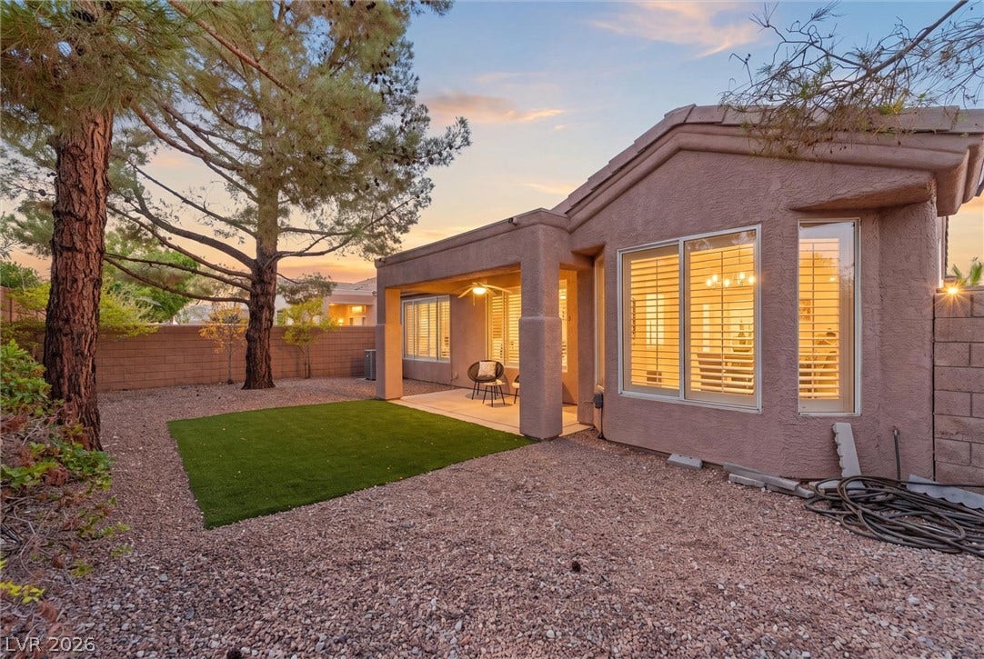 2163 Chapman Ranch Drive, Henderson, NV 89012 A covered patio overlooks a tidy back yard framed by mature trees.