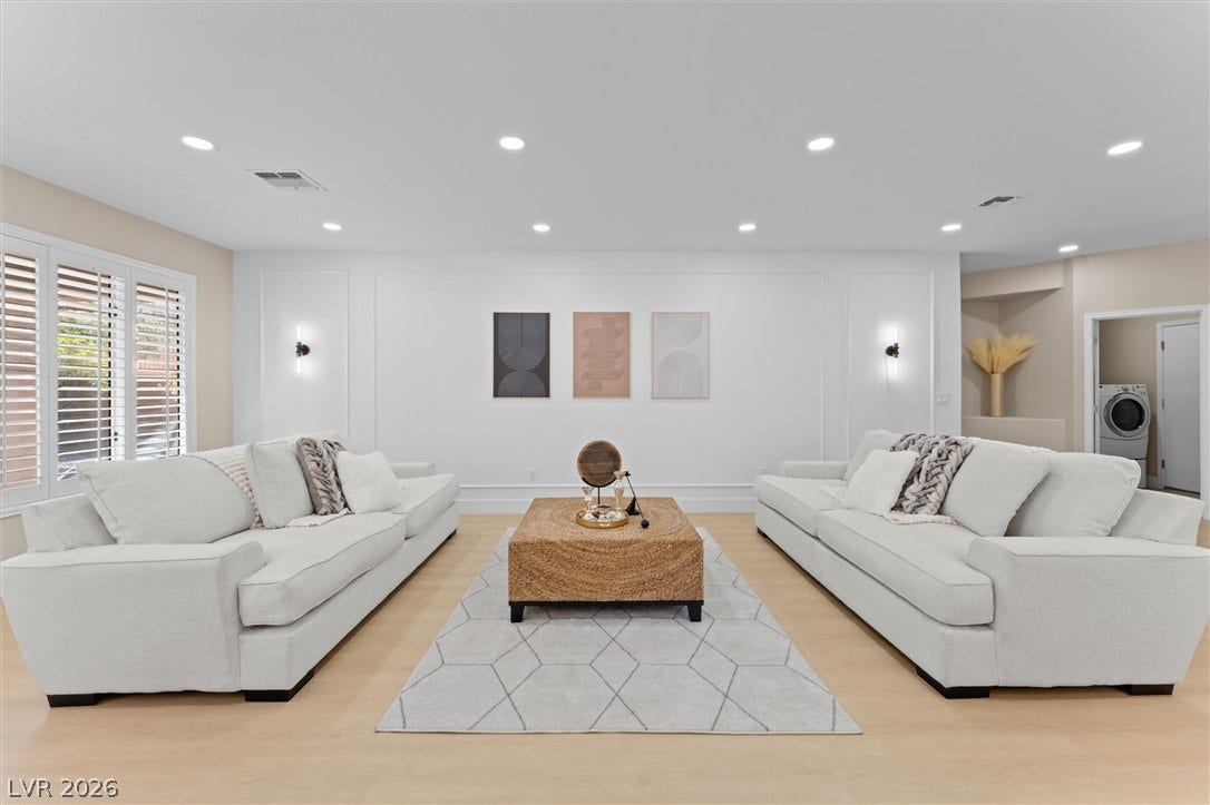 2163 Chapman Ranch Drive, Henderson, NV 89012 Recessed lighting and warm wood flooring enhance this open, modern living area.