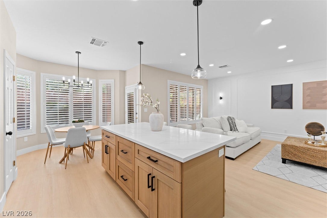 2163 Chapman Ranch Drive, Henderson, NV 89012 An open floorplan seamlessly connects the airy kitchen island with the living and dining areas.