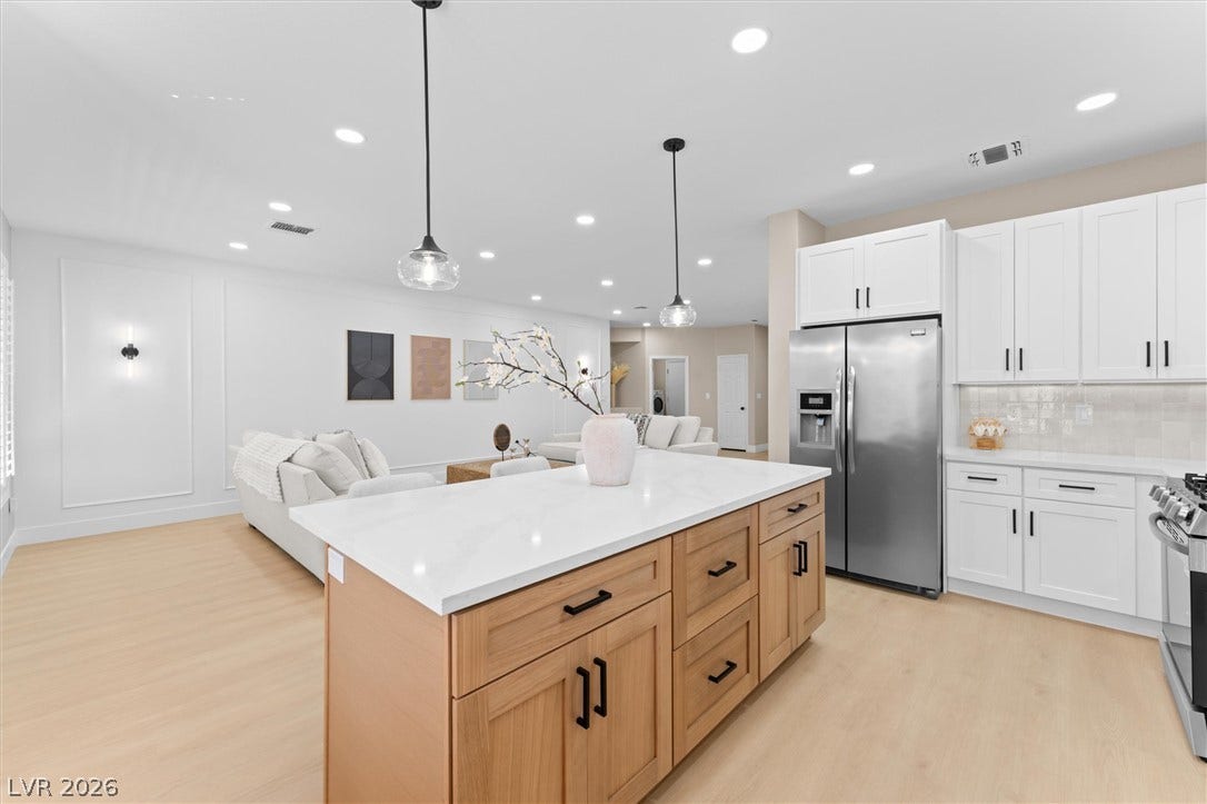 2163 Chapman Ranch Drive, Henderson, NV 89012 Streamlined cabinetry and wood flooring define this open-concept culinary space.