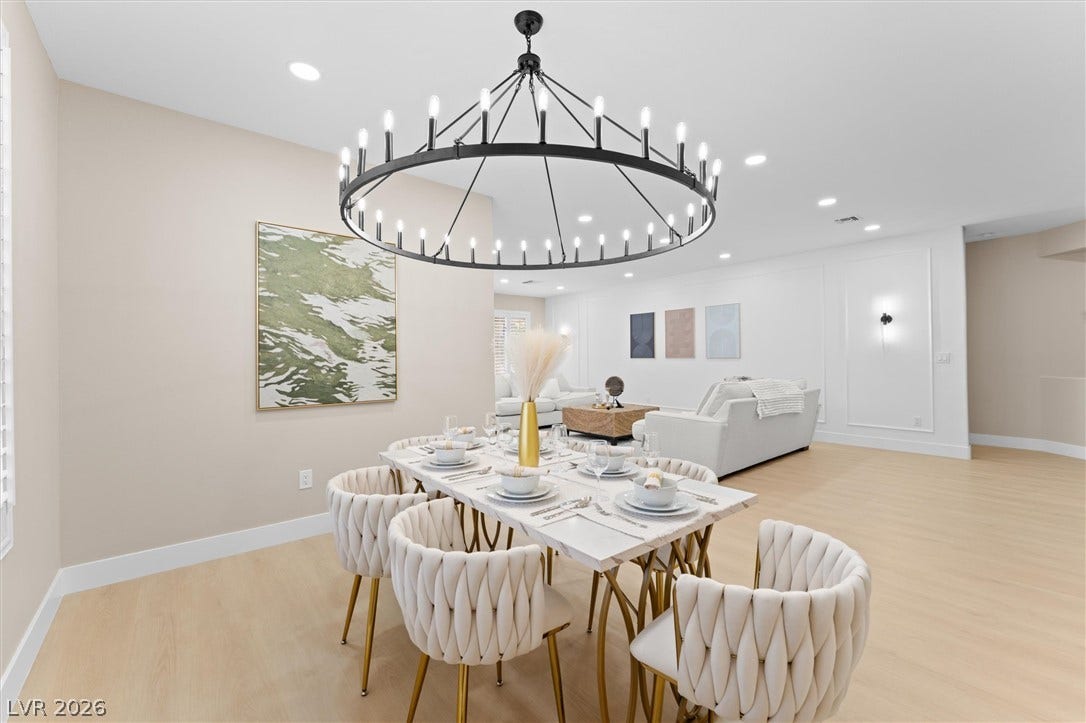 2163 Chapman Ranch Drive, Henderson, NV 89012 Smooth wood floors and elegant recessed lighting anchor this airy open-concept dining area.