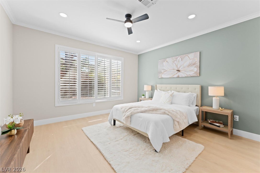 2163 Chapman Ranch Drive, Henderson, NV 89012 Sunlight filters through classic shutters onto the warm wood floors of this tranquil bedroom.