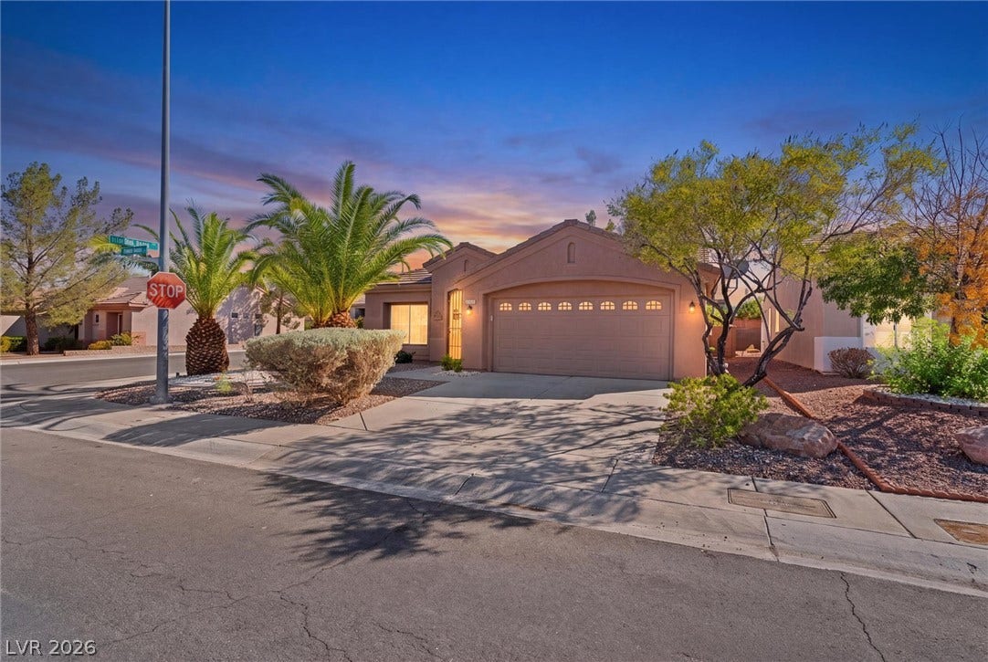 2163 Chapman Ranch Drive, Henderson, NV 89012 Desert landscaping and a paved driveway lead to this single-story home with an attached garage.