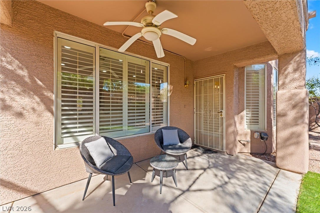 2163 Chapman Ranch Drive, Henderson, NV 89012 Shaded concrete patio features textured stucco walls and plantation shutters.