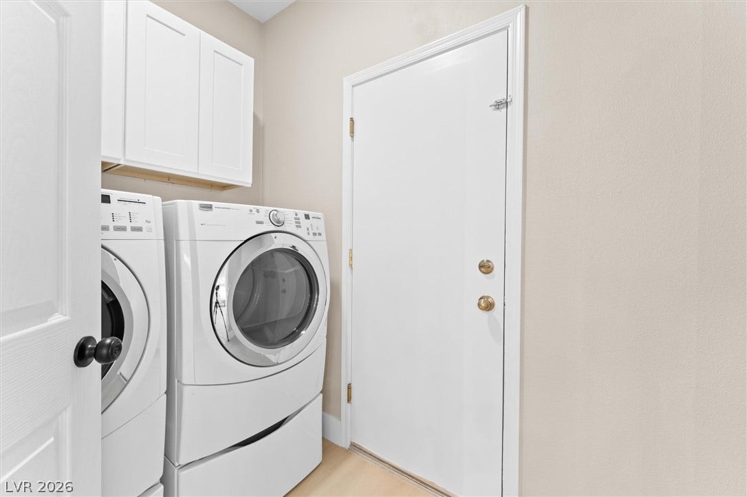 2163 Chapman Ranch Drive, Henderson, NV 89012 White cabinetry stands above laundry appliances in this highly functional utility space.