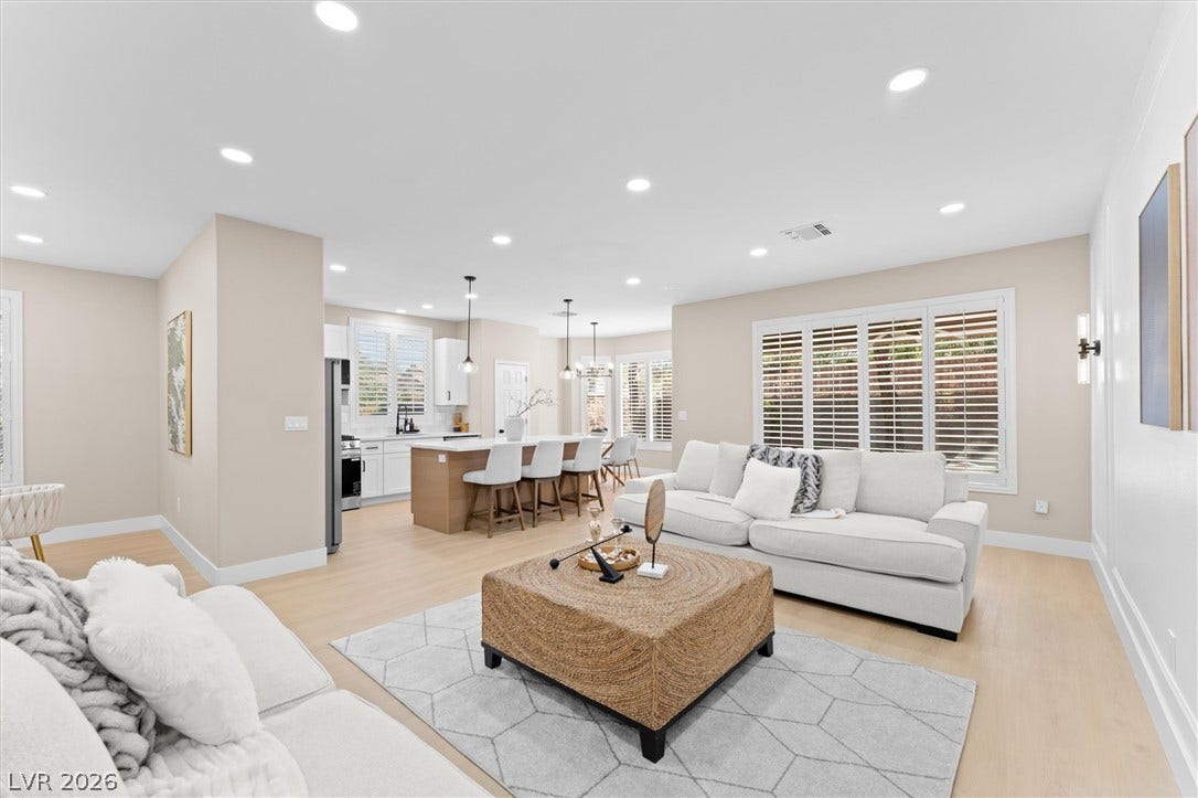 2163 Chapman Ranch Drive, Henderson, NV 89012 Recessed lighting illuminates an airy open floorplan seamlessly connecting the living area and kitchen.