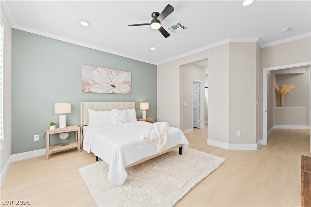 2163 Chapman Ranch Drive, Henderson, NV 89012 Smooth crown molding accents the recessed lighting and light wood floors of this bedroom.