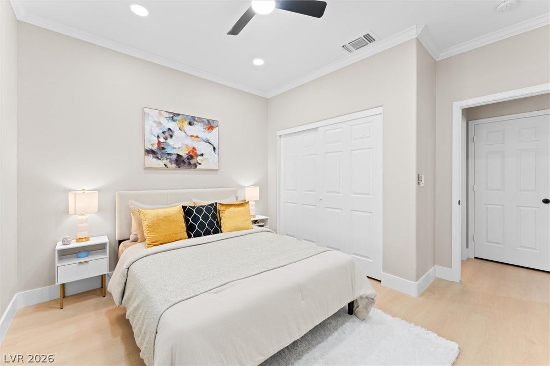 2163 Chapman Ranch Drive, Henderson, NV 89012 Smooth wood floors and crisp crown molding highlight this serene bedroom space.