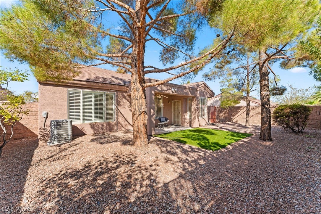 2163 Chapman Ranch Drive, Henderson, NV 89012 Mature trees shade a private back yard with a covered patio and xeriscaped groundcover.