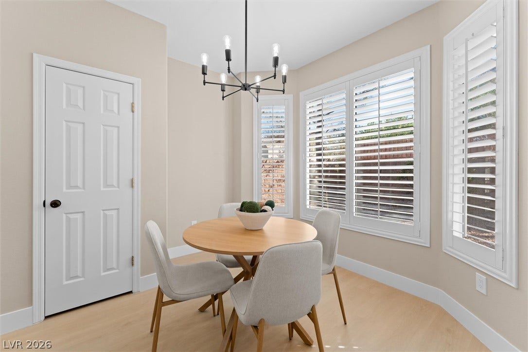 2163 Chapman Ranch Drive, Henderson, NV 89012 Elegant plantation shutters and warm wood flooring define this inviting dining space.