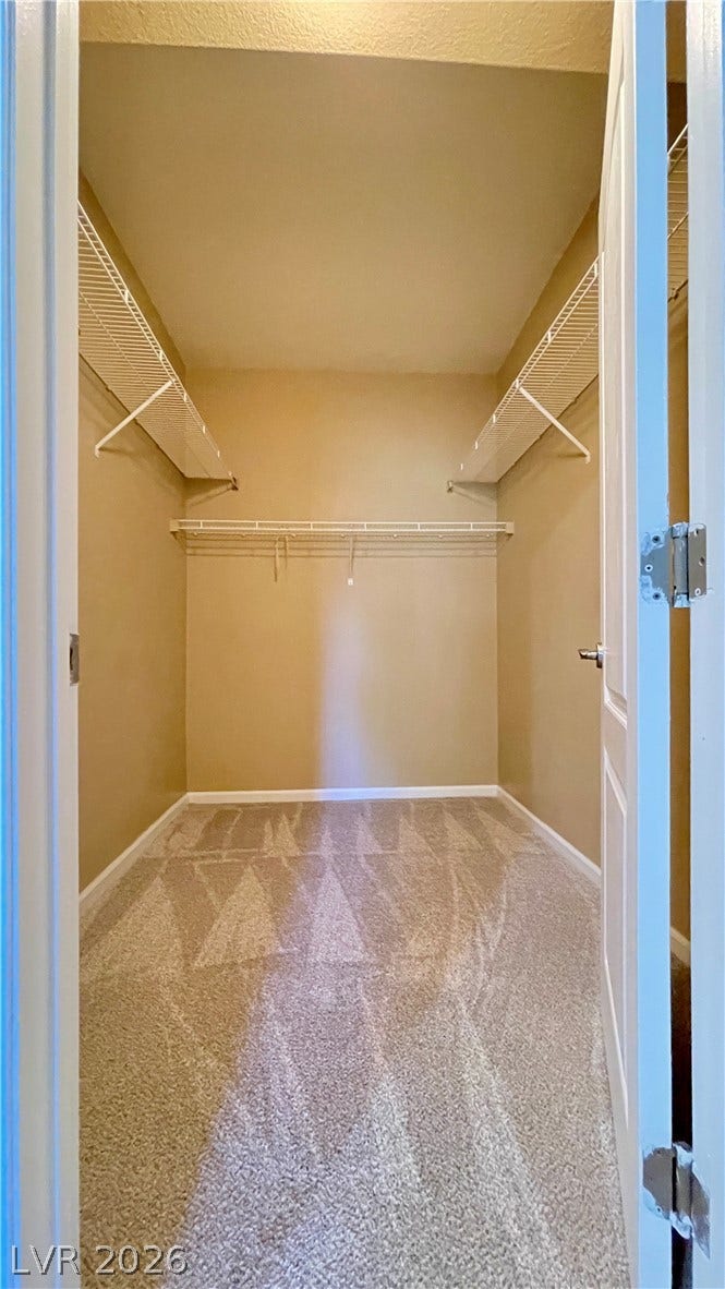 1617 Queen Victoria Street, #201, Las Vegas, NV 89144 Ample wire shelving lines this functional storage space featuring soft carpet underfoot.