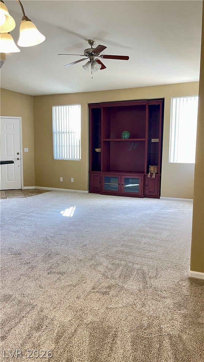 1617 Queen Victoria Street, #201, Las Vegas, NV 89144 A spacious living area featuring wall-to-wall carpeting and a large built-in media center.