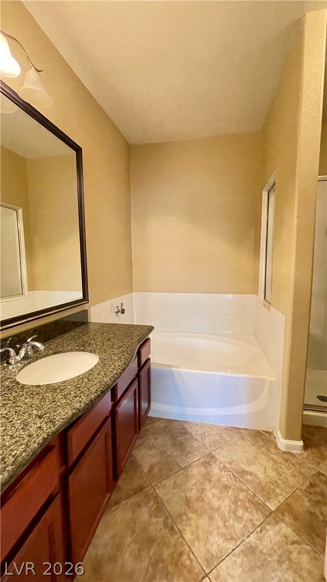 1617 Queen Victoria Street, #201, Las Vegas, NV 89144 Polished stone counters and durable tile flooring define this classic bathroom space.
