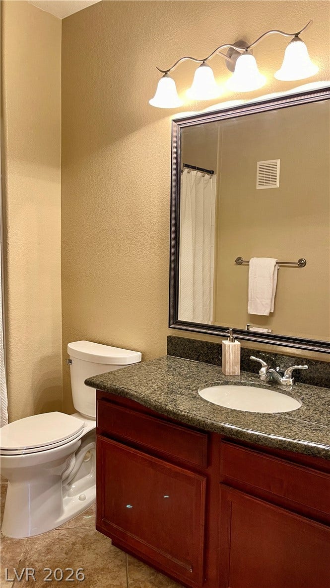 1617 Queen Victoria Street, #201, Las Vegas, NV 89144 A classic vanity with stone counters and a framed mirror highlights this full bathroom with shower/ tub combo.