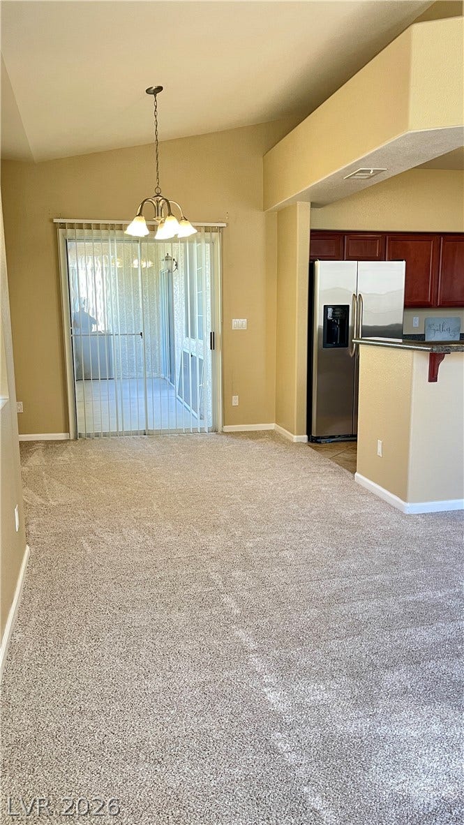 1617 Queen Victoria Street, #201, Las Vegas, NV 89144 Vaulted ceilings and broad sliding doors create an airy atmosphere in this versatile dining area.