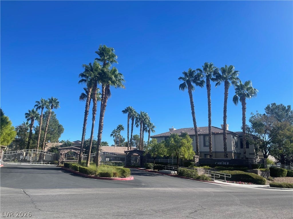 1617 Queen Victoria Street, #201, Las Vegas, NV 89144 Towering palm trees frame the gated entrance to this residential community.