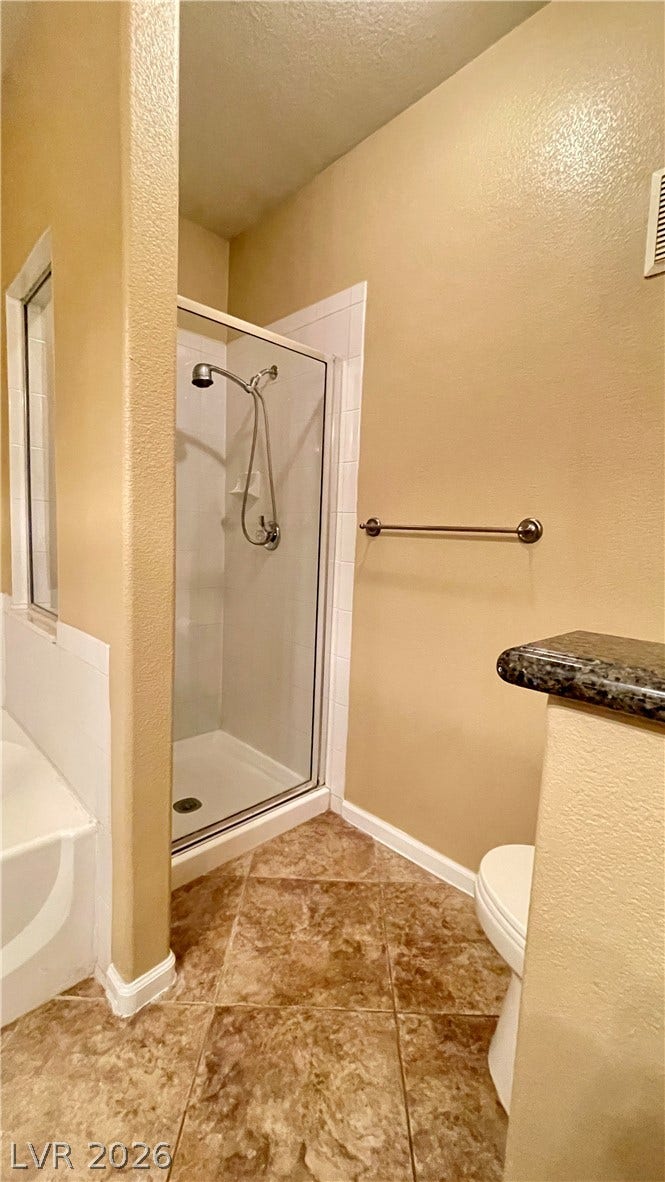 1617 Queen Victoria Street, #201, Las Vegas, NV 89144 A glass-enclosed walk-in shower highlights this functional bathroom space.