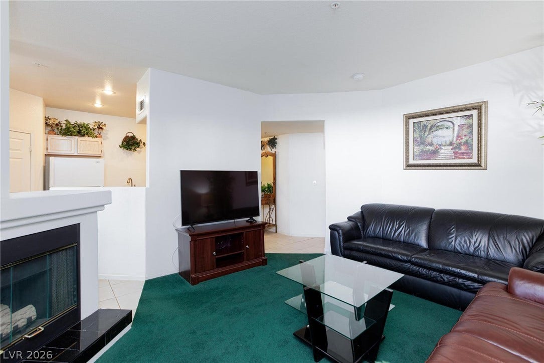An inviting fireplace complements the open-concept layout of this cozy living space.
