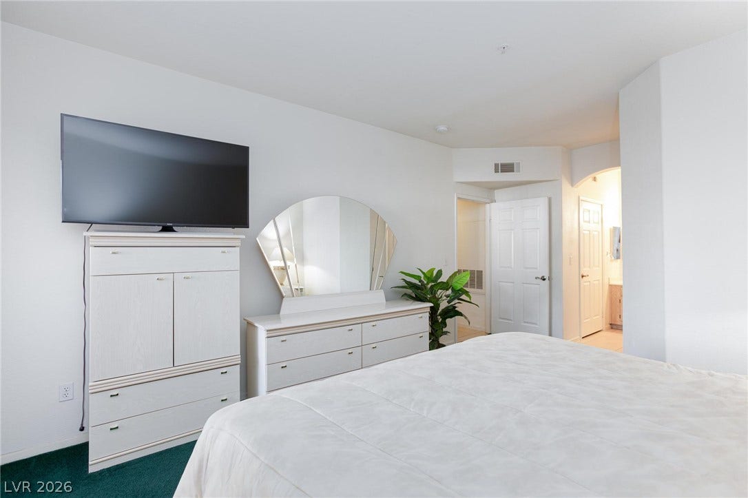 An inviting private retreat offers plush carpeting and a direct doorway leading to the bathroom.