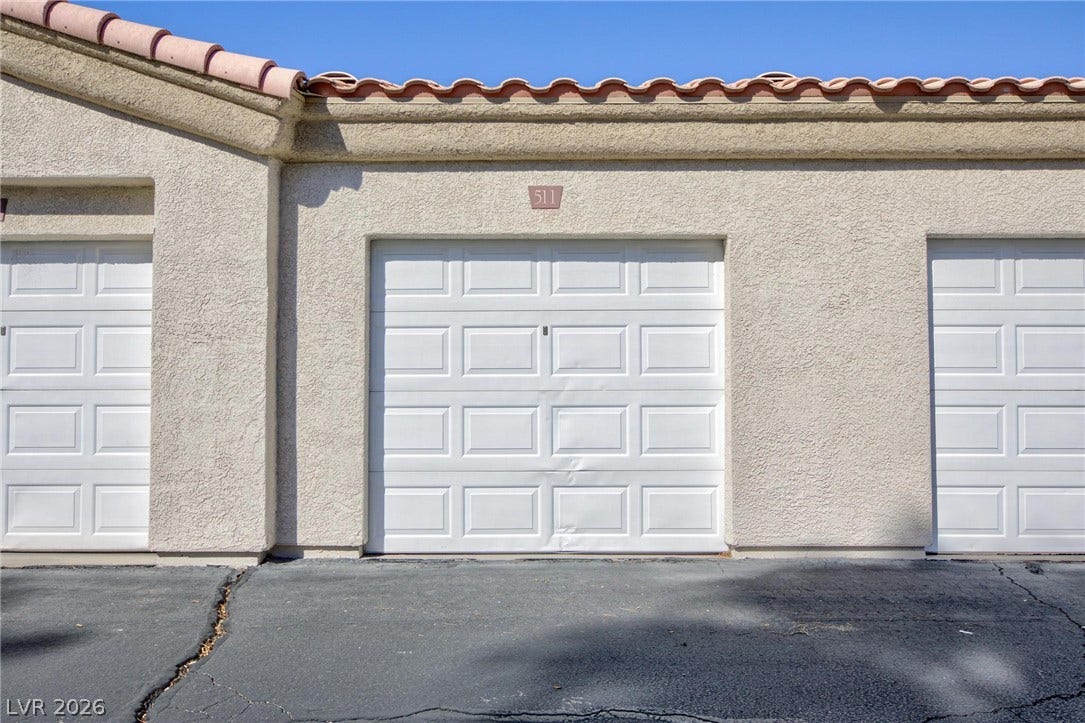 Stucco exterior finishes and Spanish tile roofing define the architectural style of this garage structure.
