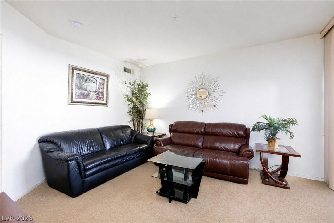 Smooth plaster walls and neutral carpeting define this comfortable, versatile living space.