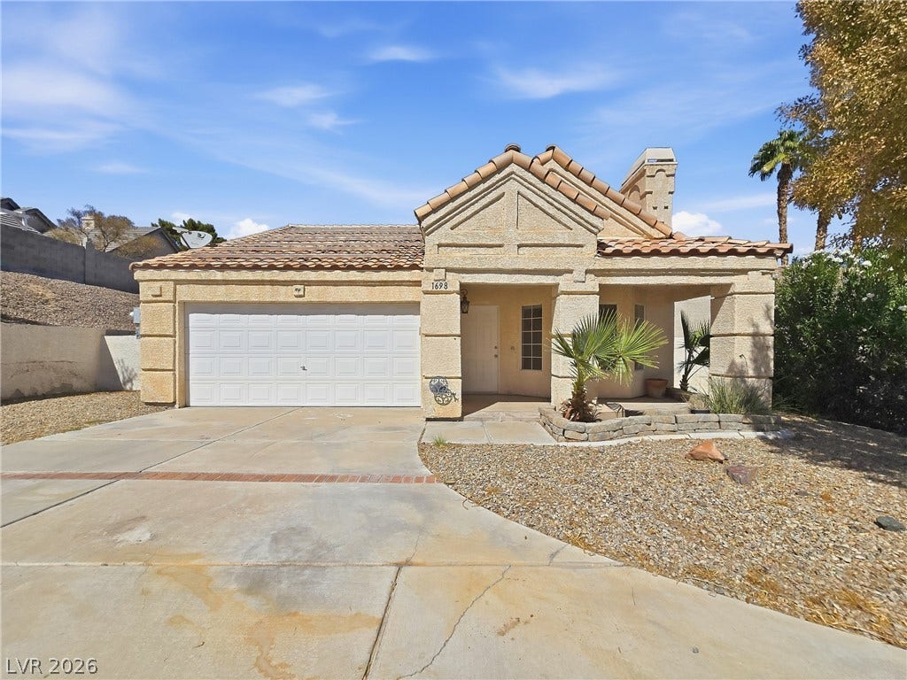 Spanish tile roofing and textured stucco walls define this classic desert residence.