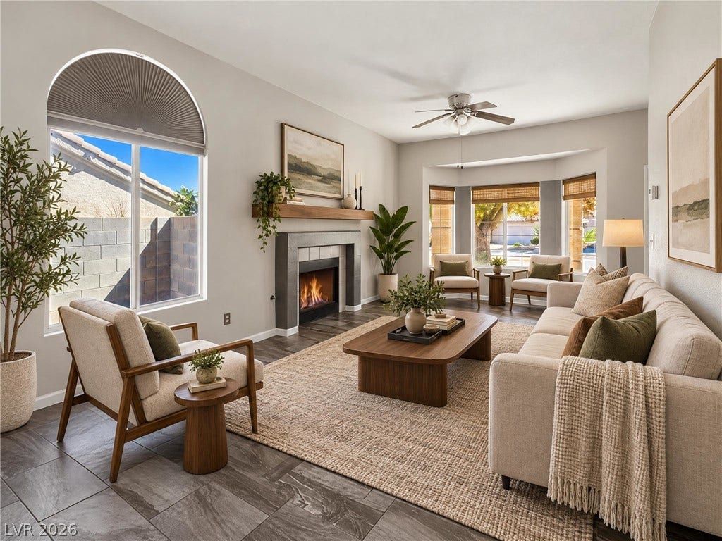 ** Virtually Staged**  Arched windows and a modern fireplace bring architectural character to this open living space.