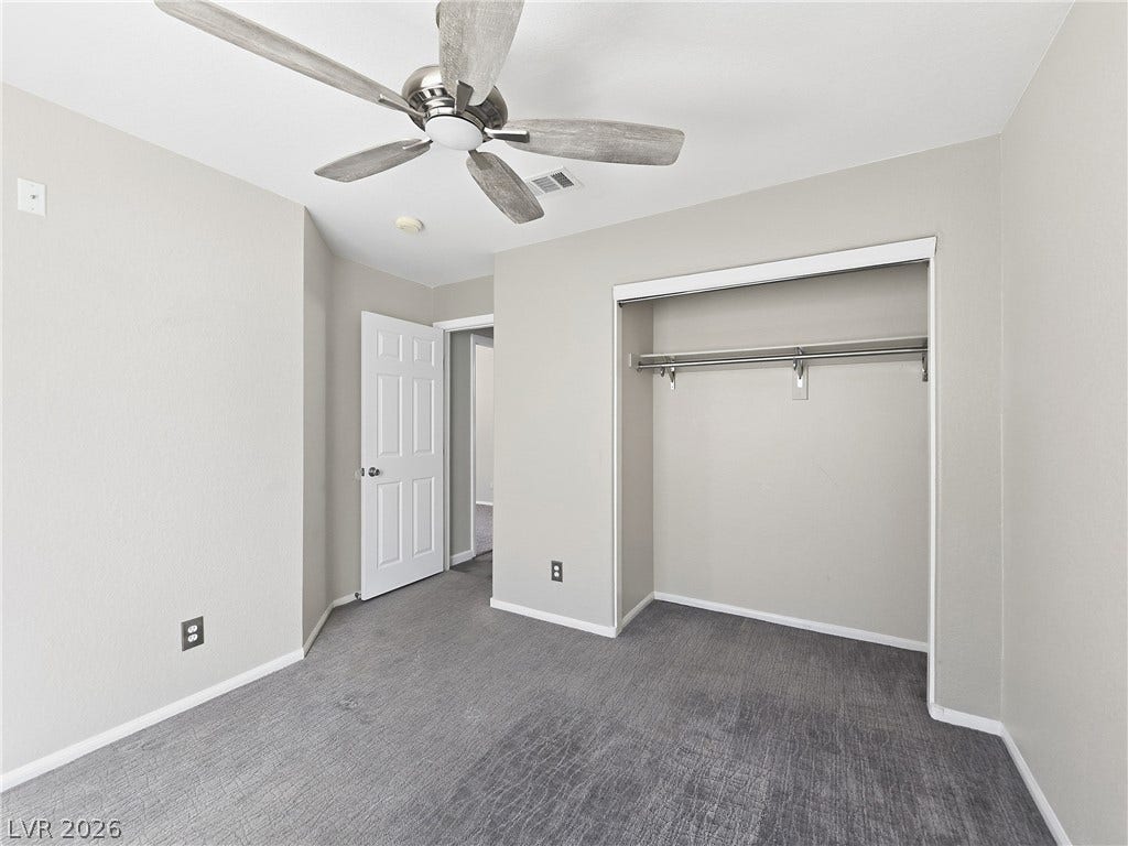 New carpet in bedroom.  Smooth carpeting pairs with clean neutral walls under a classic paneled ceiling design.