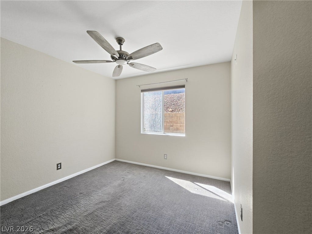 New carpet in bedroom.  Plush carpeting and a single window define this comfortable, neutral-toned bedroom space.