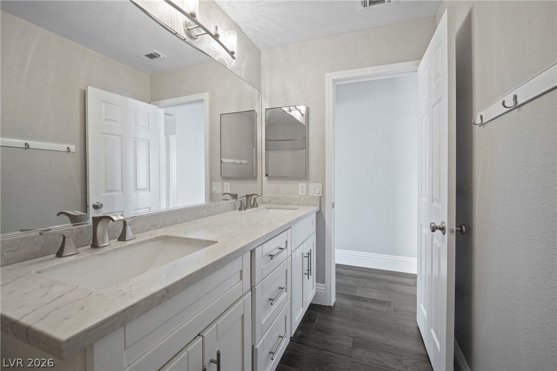 Clean lines and a spacious dual vanity define this modern bathroom.