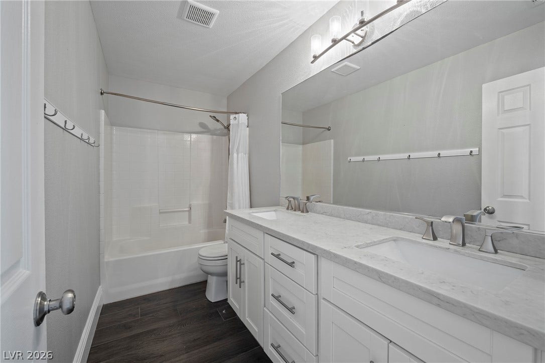 Clean lines and a spacious dual vanity define this modern bathroom space.