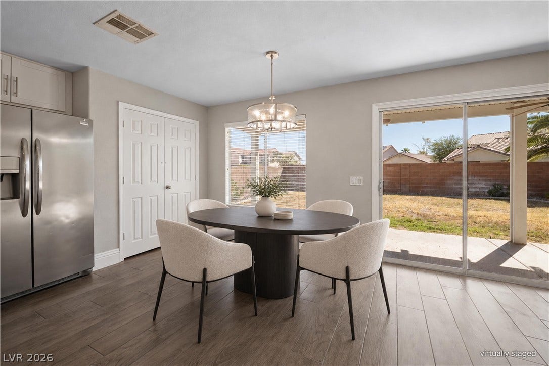 Sliding glass doors open from the dining area directly onto the rear patio.