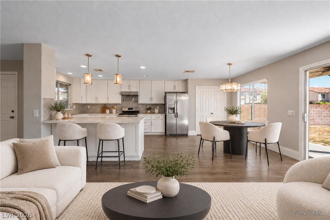 An airy open-concept layout connects the kitchen, dining space, and living areas seamlessly.