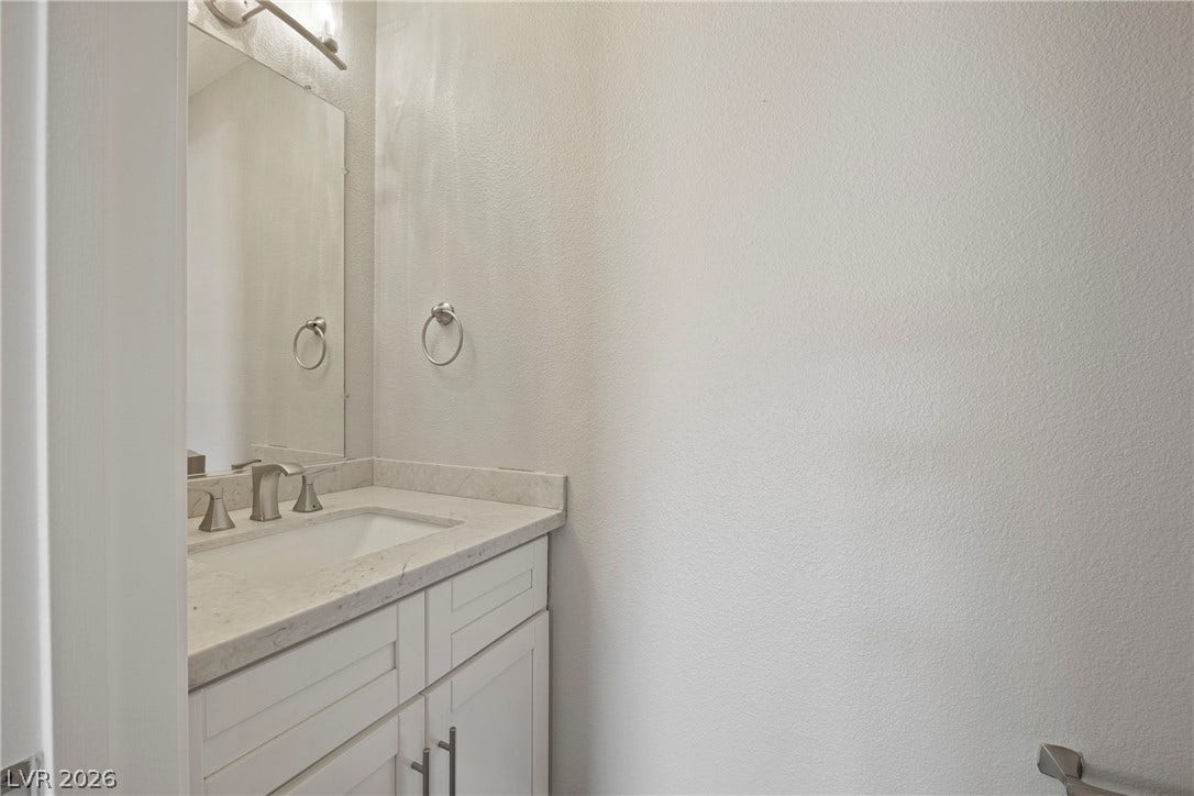 Clean lines and stone counters highlight this understated washroom space.
