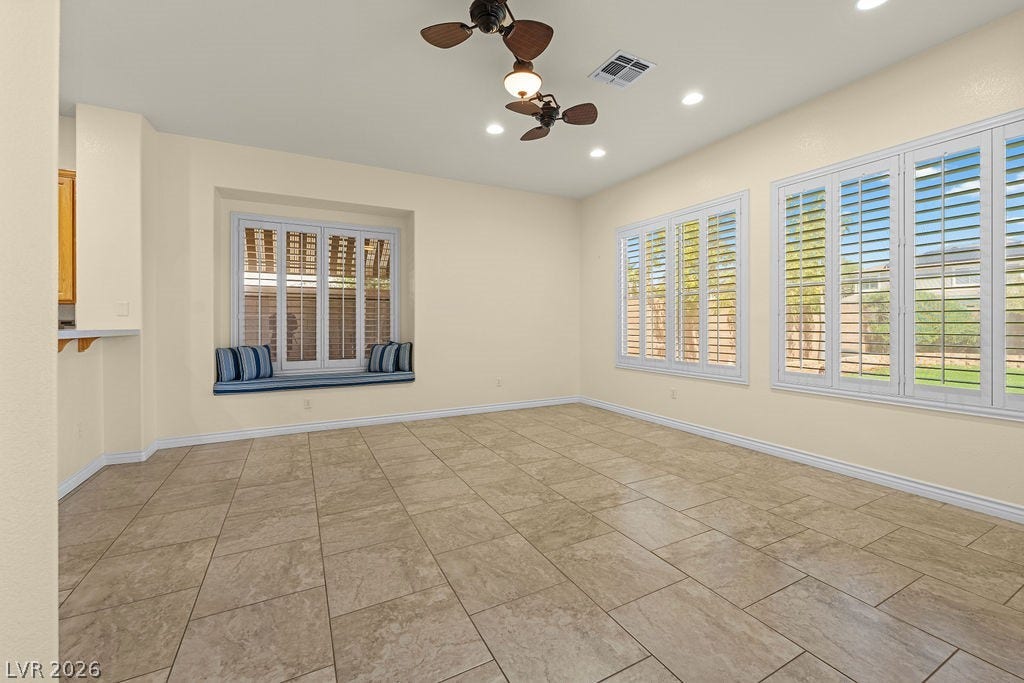 This bright and airy room features ample natural light and a comfortable window seat.