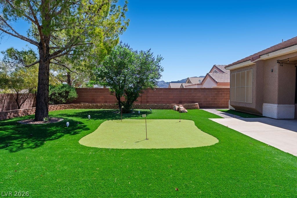 This private yard features a putting green for endless outdoor enjoyment.