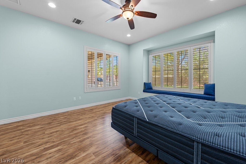 This spacious room features ample natural light and durable wood flooring.